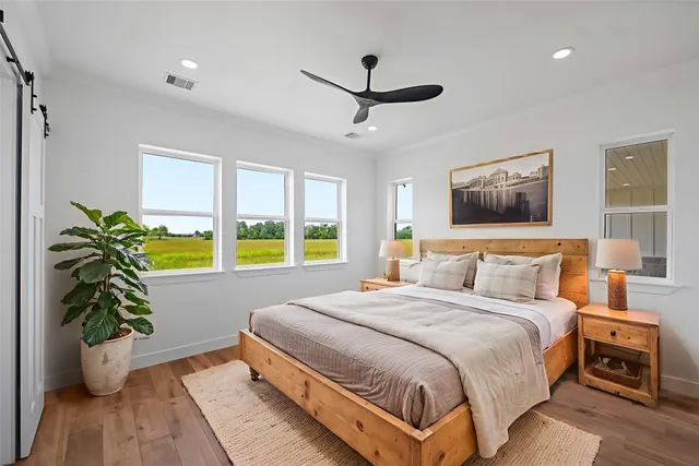 a spacious bedroom with a bed and a potted plant