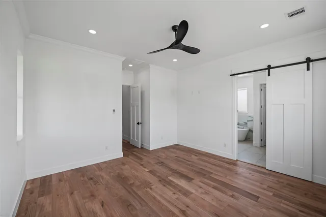 a view of empty room with wooden floor
