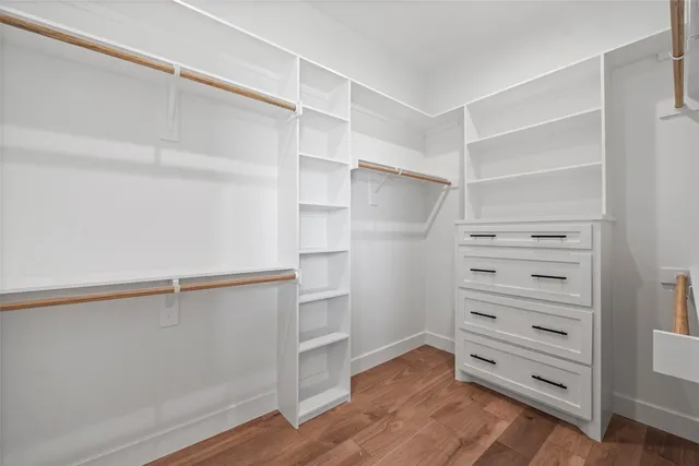 a view of walk in closet with empty racks