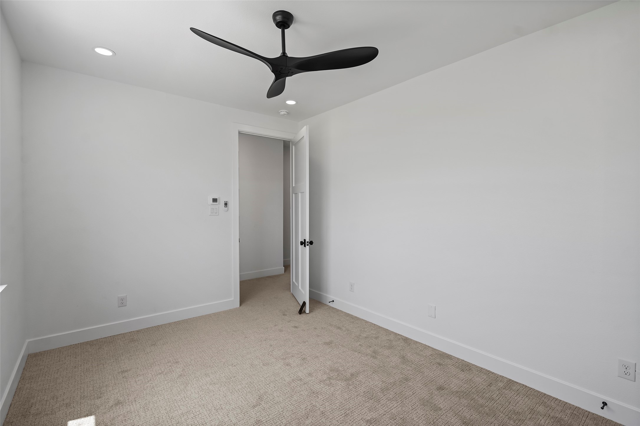 413 Chuckwagon Trail Angleton, TX 77515 - Photo 34 of 46 en empty room with a fan and a ceiling fan