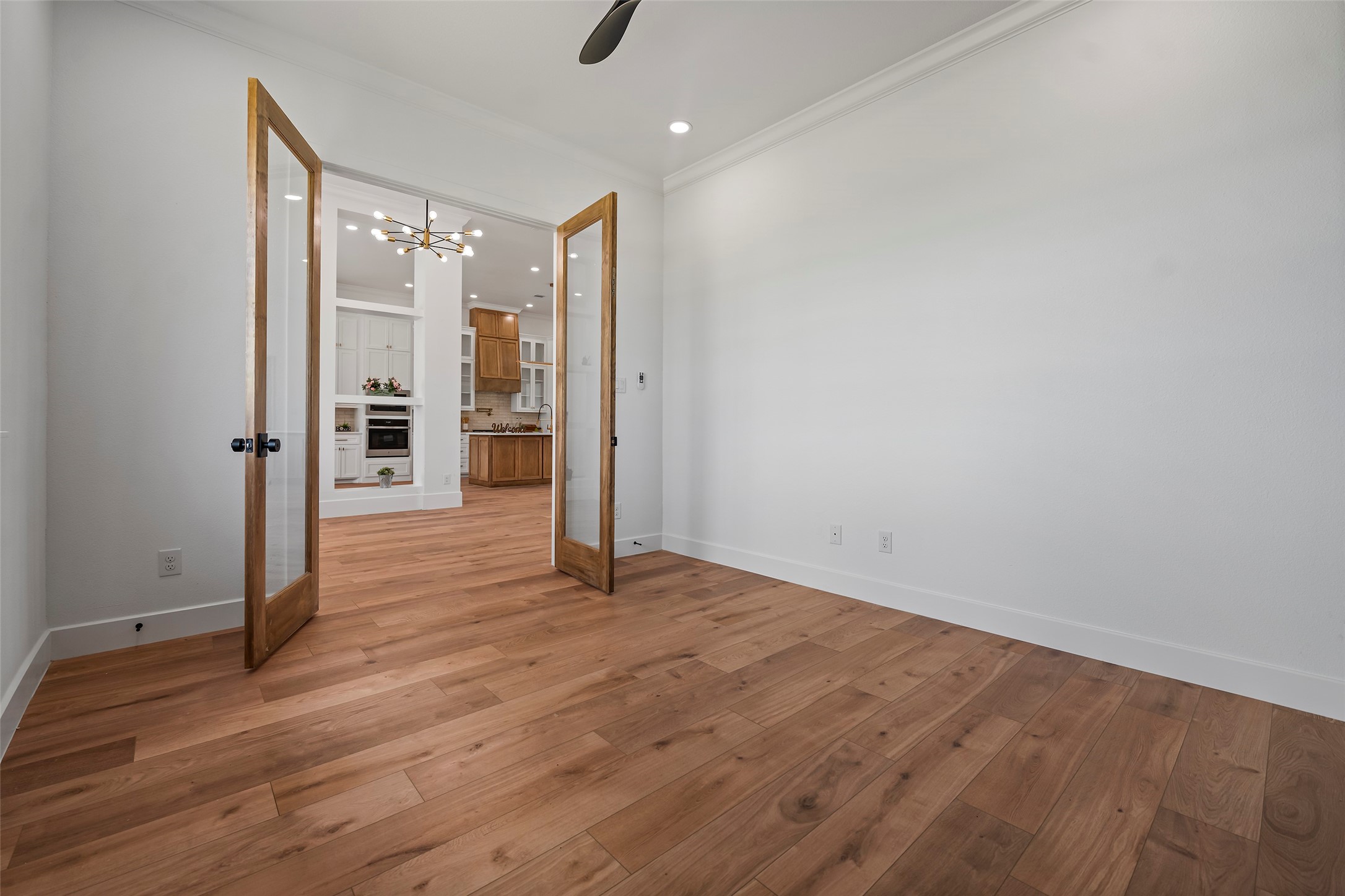 413 Chuckwagon Trail Angleton, TX 77515 - Photo 5 of 46 a view of an empty room with wooden floor and a window