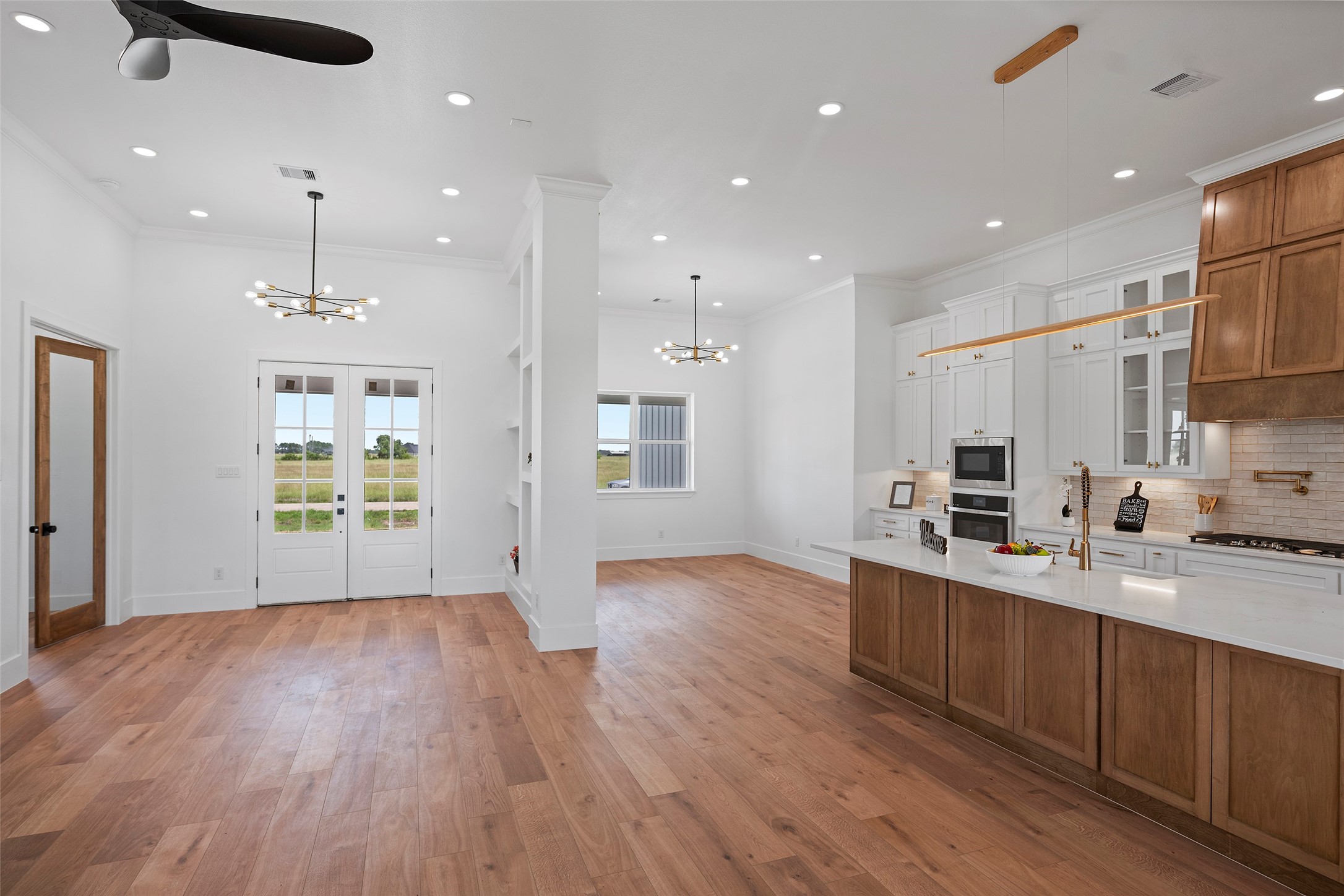 413 Chuckwagon Trail Angleton, TX 77515 - Photo 7 of 46 a kitchen with stainless steel appliances granite countertop a sink a stove a refrigerator and a microwave