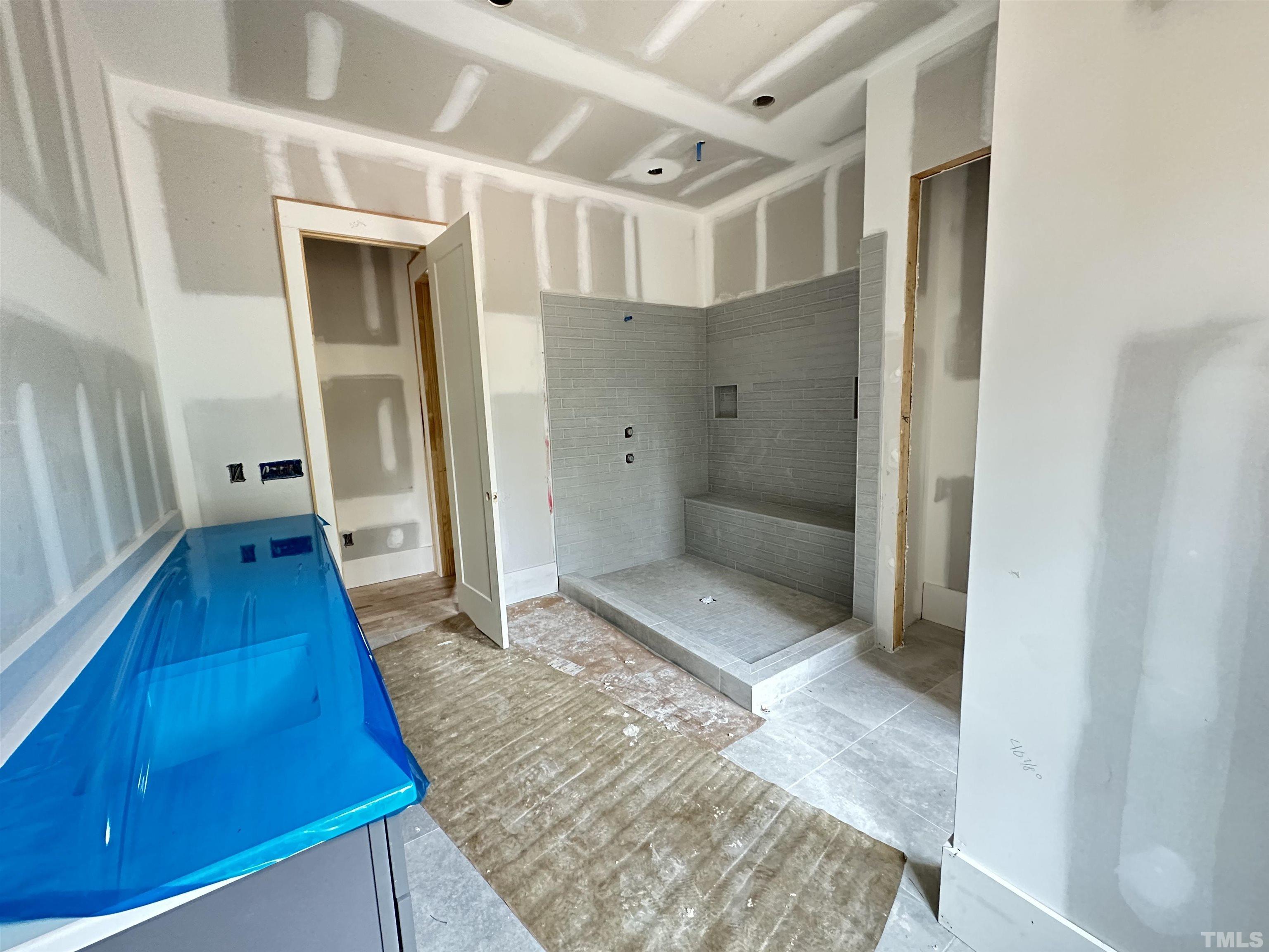 1509 Starry Night Court Raleigh, NC 27613 - Photo 5 of 14 a bathroom with a tub and shower