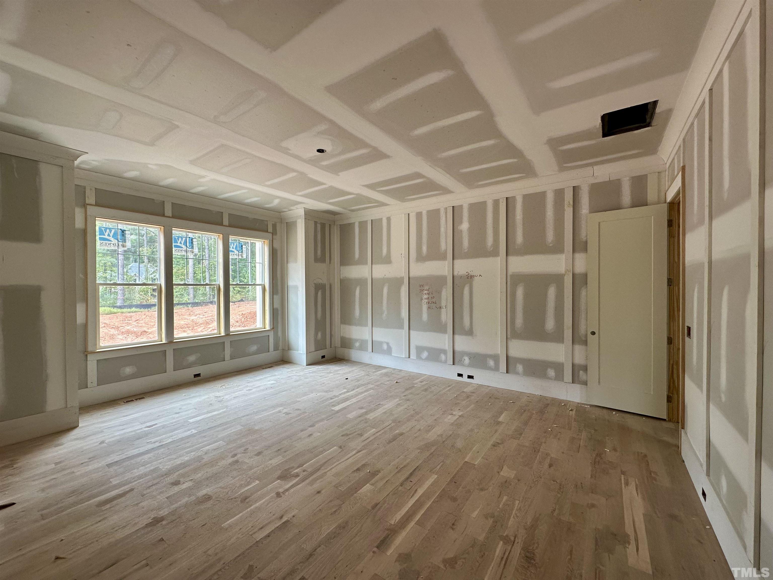 1509 Starry Night Court Raleigh, NC 27613 - Photo 7 of 14 a view of an empty room with wooden floor and a window