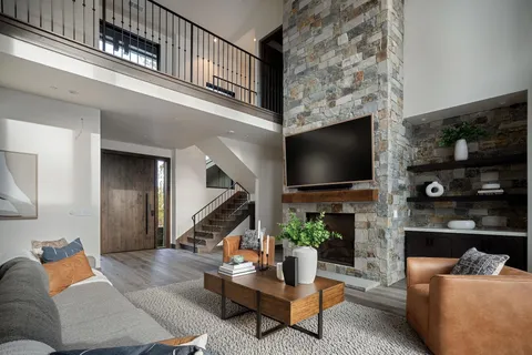 a dining room with stainless steel appliances kitchen island granite countertop a table chairs and a view of living room