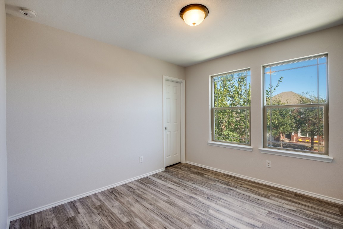 211 Mancos Drive Georgetown, TX 78626 - Photo 10 of 25 an empty room with wooden floor and windows