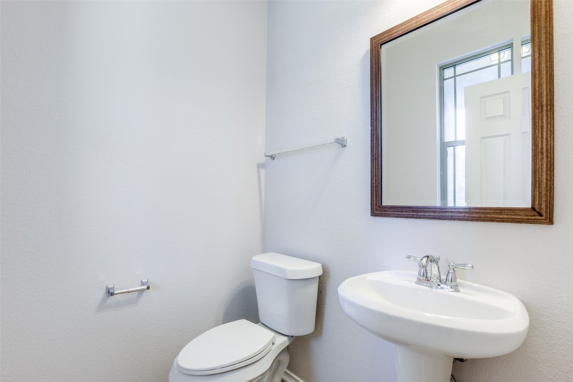 211 Mancos Drive Georgetown, TX 78626 - Photo 14 of 25 a bathroom with a sink a toilet and mirror