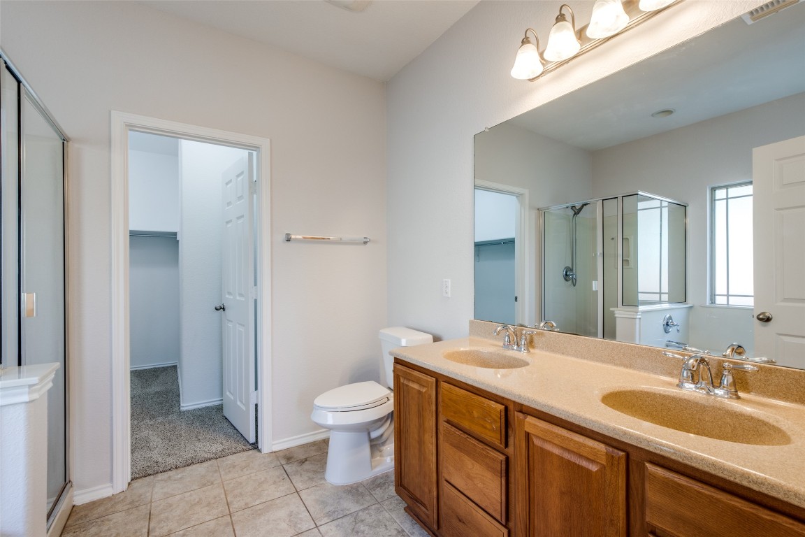 211 Mancos Drive Georgetown, TX 78626 - Photo 15 of 25 a bathroom with a granite countertop sink a toilet and a mirror