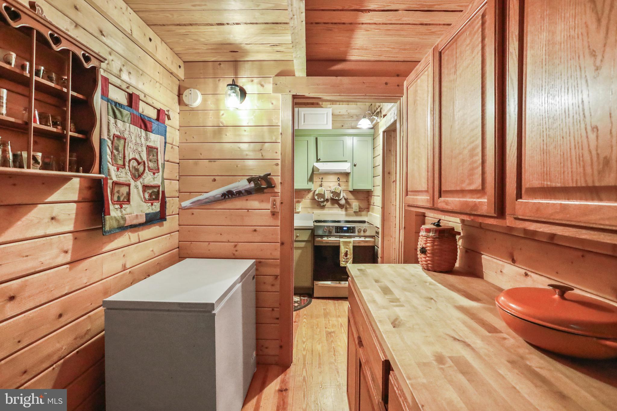 333 Rouse Mountain Road Great Cacapon, WV 25422 - Photo 12 of 54 a kitchen with stainless steel appliances kitchen island granite countertop a sink and cabinets