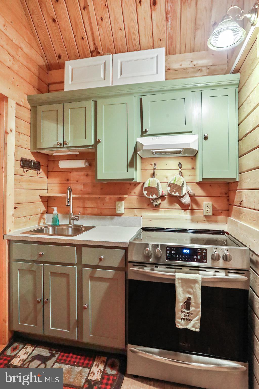 333 Rouse Mountain Road Great Cacapon, WV 25422 - Photo 13 of 54 a stove top oven sitting inside of a kitchen