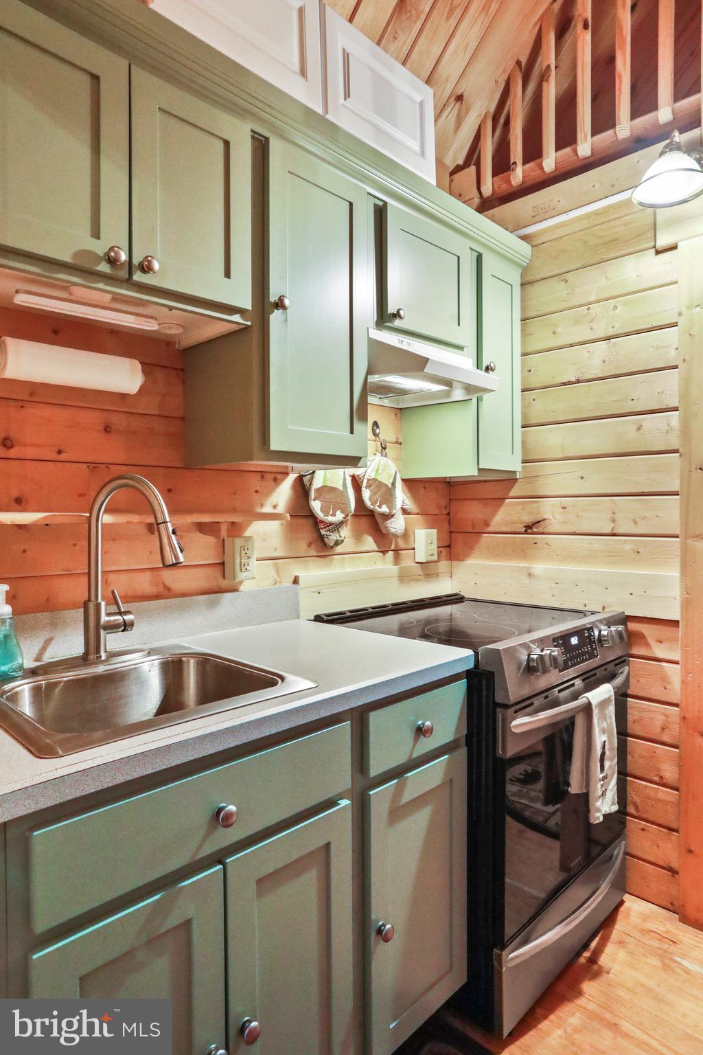 333 Rouse Mountain Road Great Cacapon, WV 25422 - Photo 14 of 54 a kitchen with stainless steel appliances granite countertop a sink and a stove