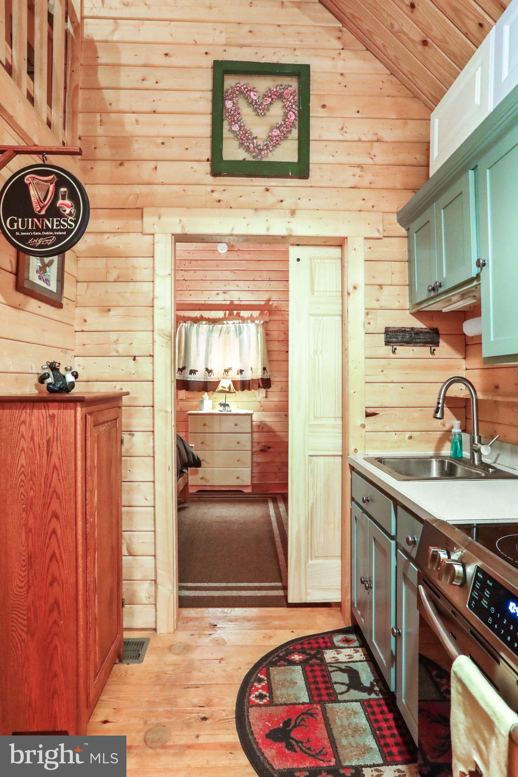 333 Rouse Mountain Road Great Cacapon, WV 25422 - Photo 16 of 54 a kitchen with stainless steel appliances granite countertop a stove a sink and a microwave