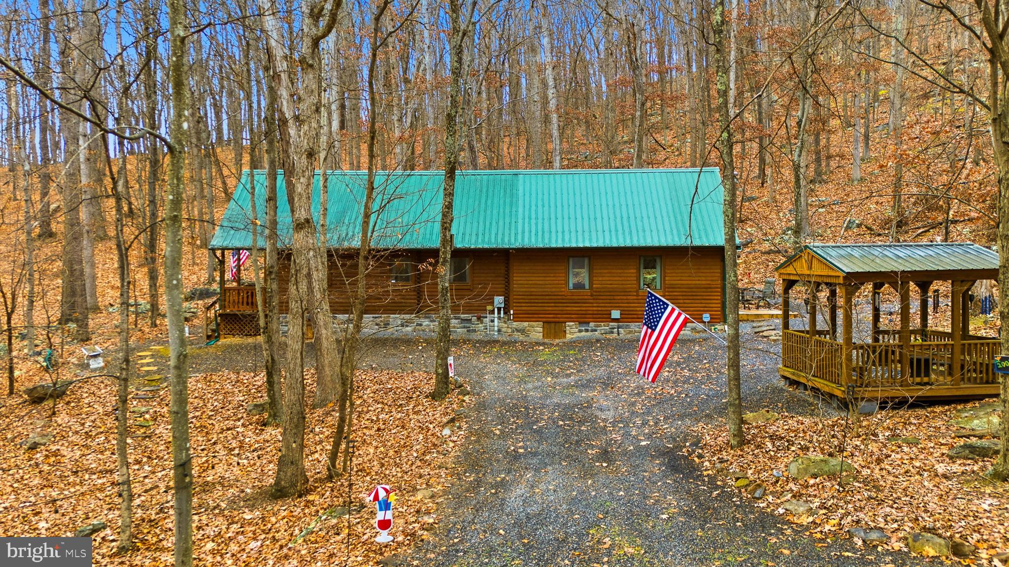 333 Rouse Mountain Road Great Cacapon, WV 25422 - Photo 3 of 54 a backyard of a house with barbeque oven