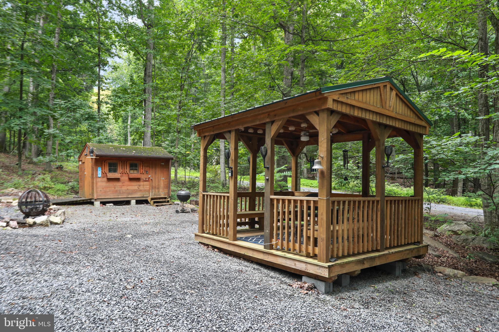 333 Rouse Mountain Road Great Cacapon, WV 25422 - Photo 42 of 54 a view of a small house with a small yard and wooden fence