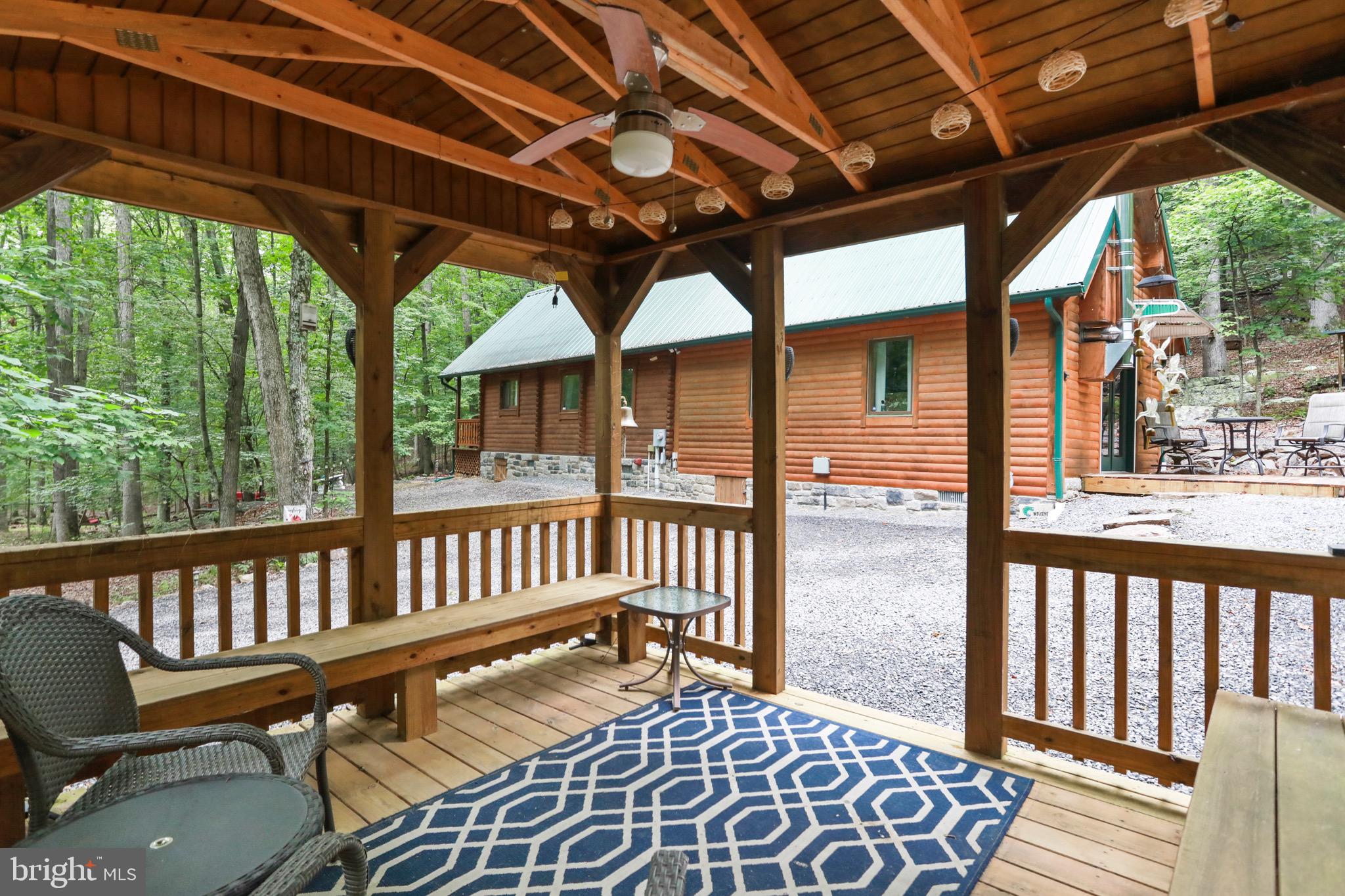 333 Rouse Mountain Road Great Cacapon, WV 25422 - Photo 43 of 54 a view of a chair and tables in the balcony