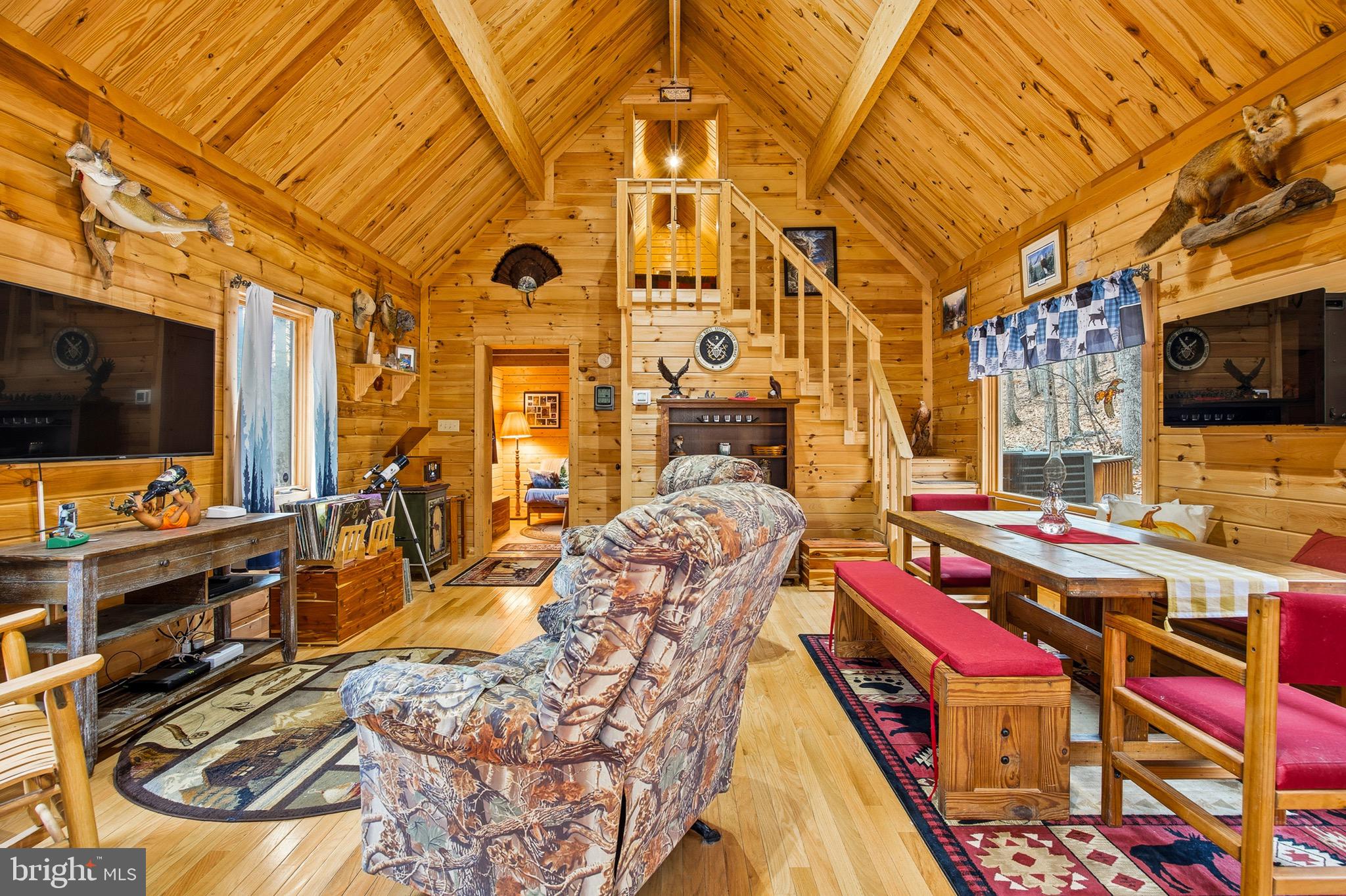 333 Rouse Mountain Road Great Cacapon, WV 25422 - Photo 5 of 54 a bedroom with furniture and a flat screen tv