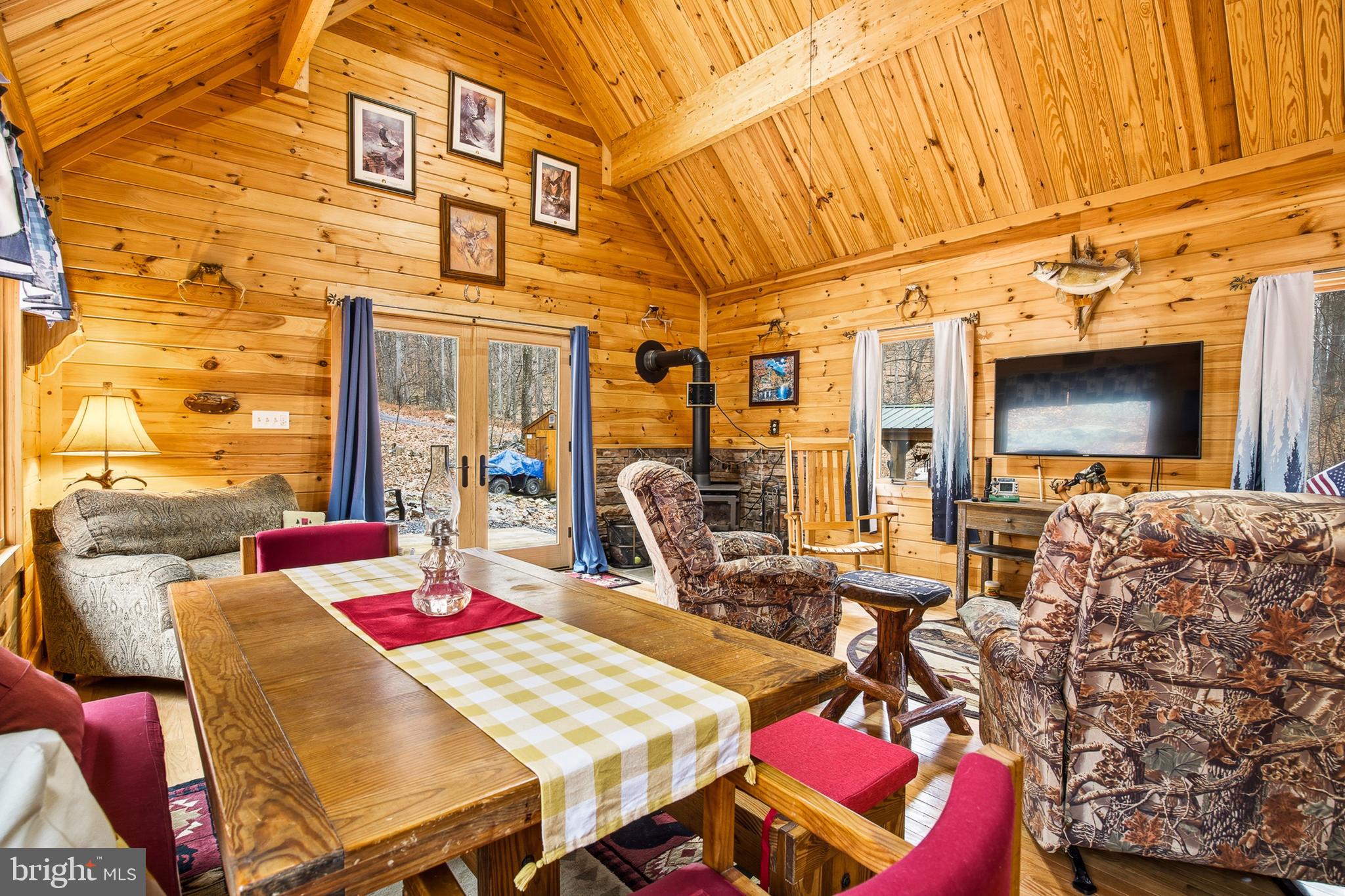 333 Rouse Mountain Road Great Cacapon, WV 25422 - Photo 9 of 54 a view of a dining room with furniture a chandelier and wooden floor