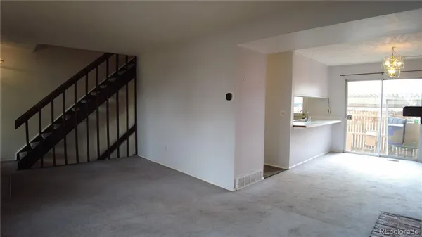 a view of a hallway with kitchen and entryway