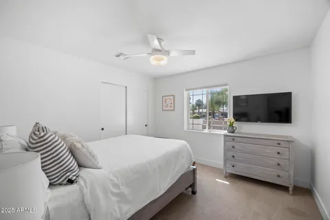 a bedroom with a bed and a flat screen tv