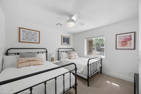 a bedroom with two beds and a window