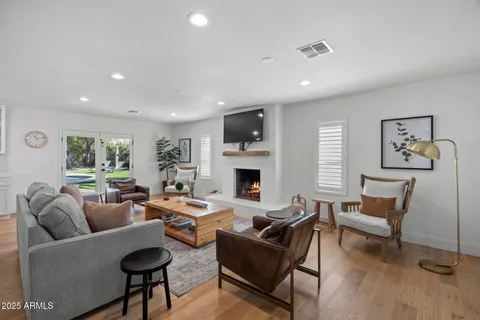 a living room with fireplace furniture and a wooden floor
