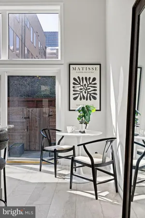 a living room with furniture potted plant and a mirror