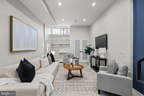 a living room with furniture and a potted plant