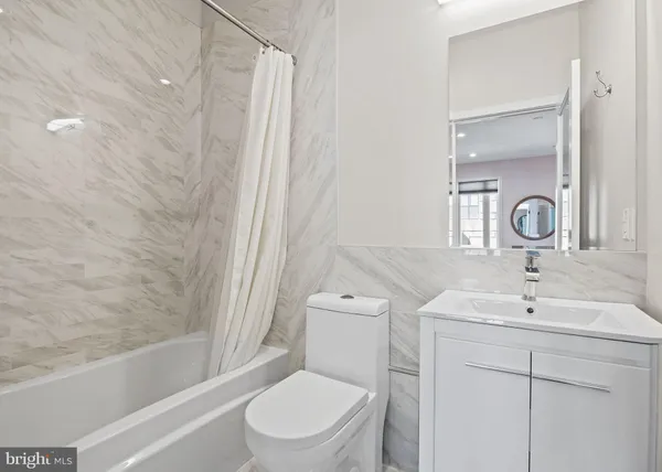 a bathroom with a shower sink and mirror