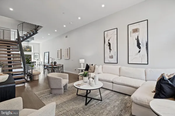 a dining room with furniture and wooden floor