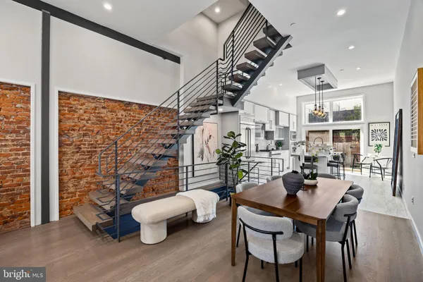 a kitchen with stainless steel appliances a dining table chairs stove and refrigerator