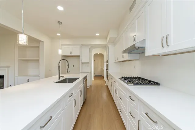 a view of an empty room with a window and cabinet