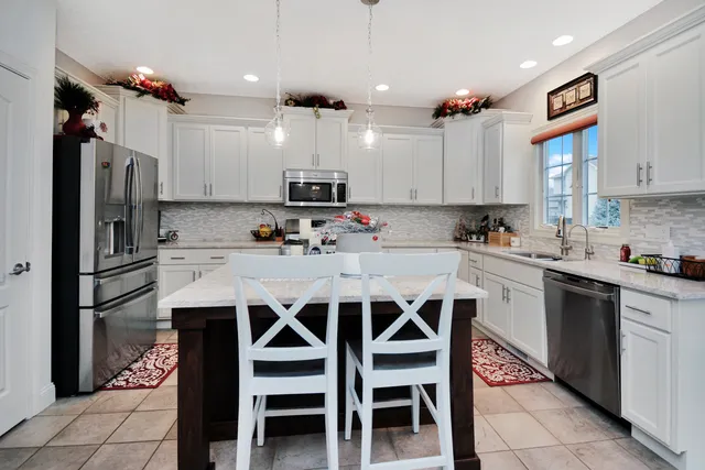 a spacious bathroom with a granite countertop sink a mirror and shower