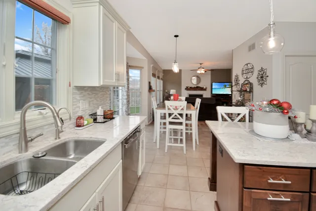 a spacious bathroom with a granite countertop sink a toilet mirror and bathtub