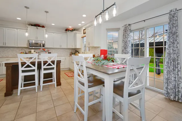 a bedroom with a bed lamp and a chandelier
