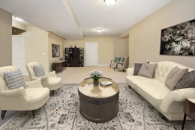 a dining room with wooden floor a chandelier a wooden table and chairs