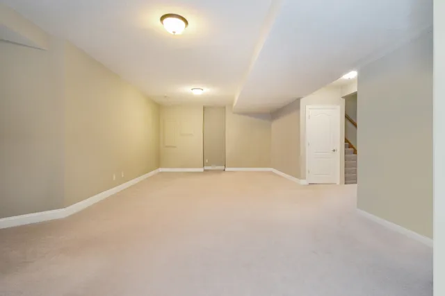 a kitchen with white cabinets and sink