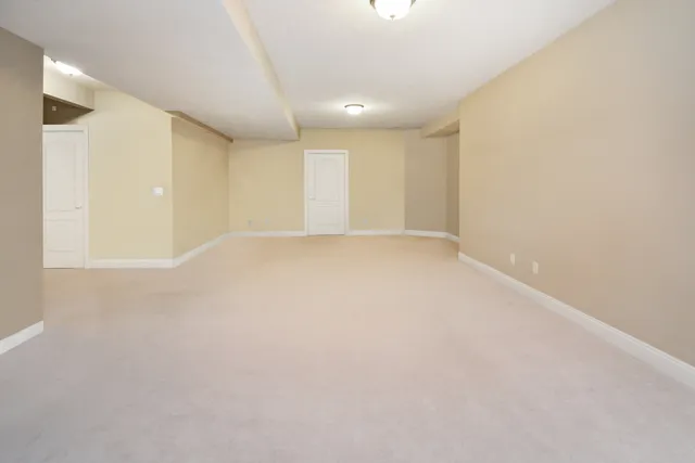 a kitchen with stainless steel appliances kitchen island granite countertop a table chairs and a refrigerator
