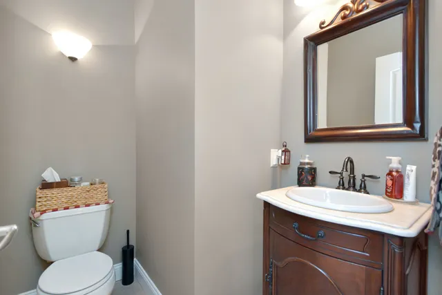 a kitchen with a sink white cabinets and stainless steel appliances