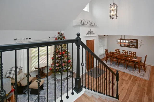 a view of a house with a big yard plants and large trees