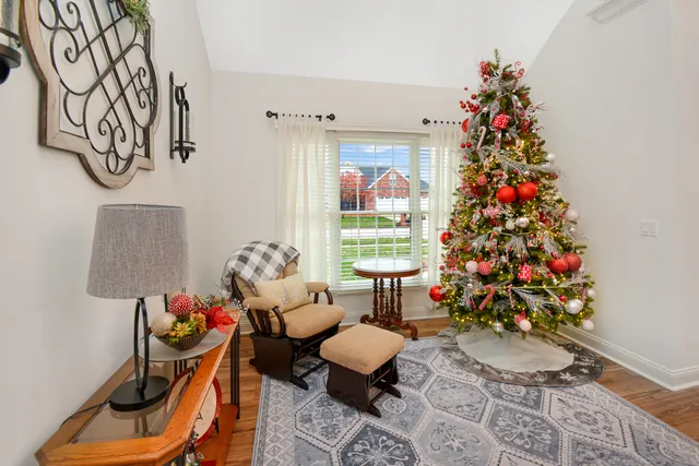 a view of a patio with a table chairs and a barbeque