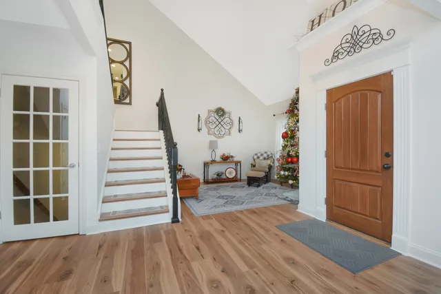 a view of a livingroom with wooden floor and stairs