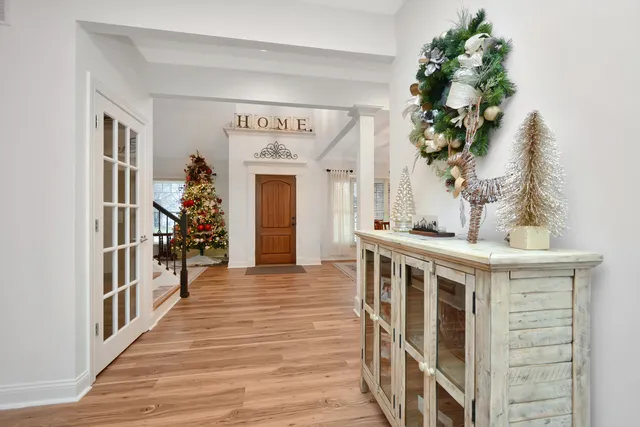 a living room with furniture a fireplace and a chandelier
