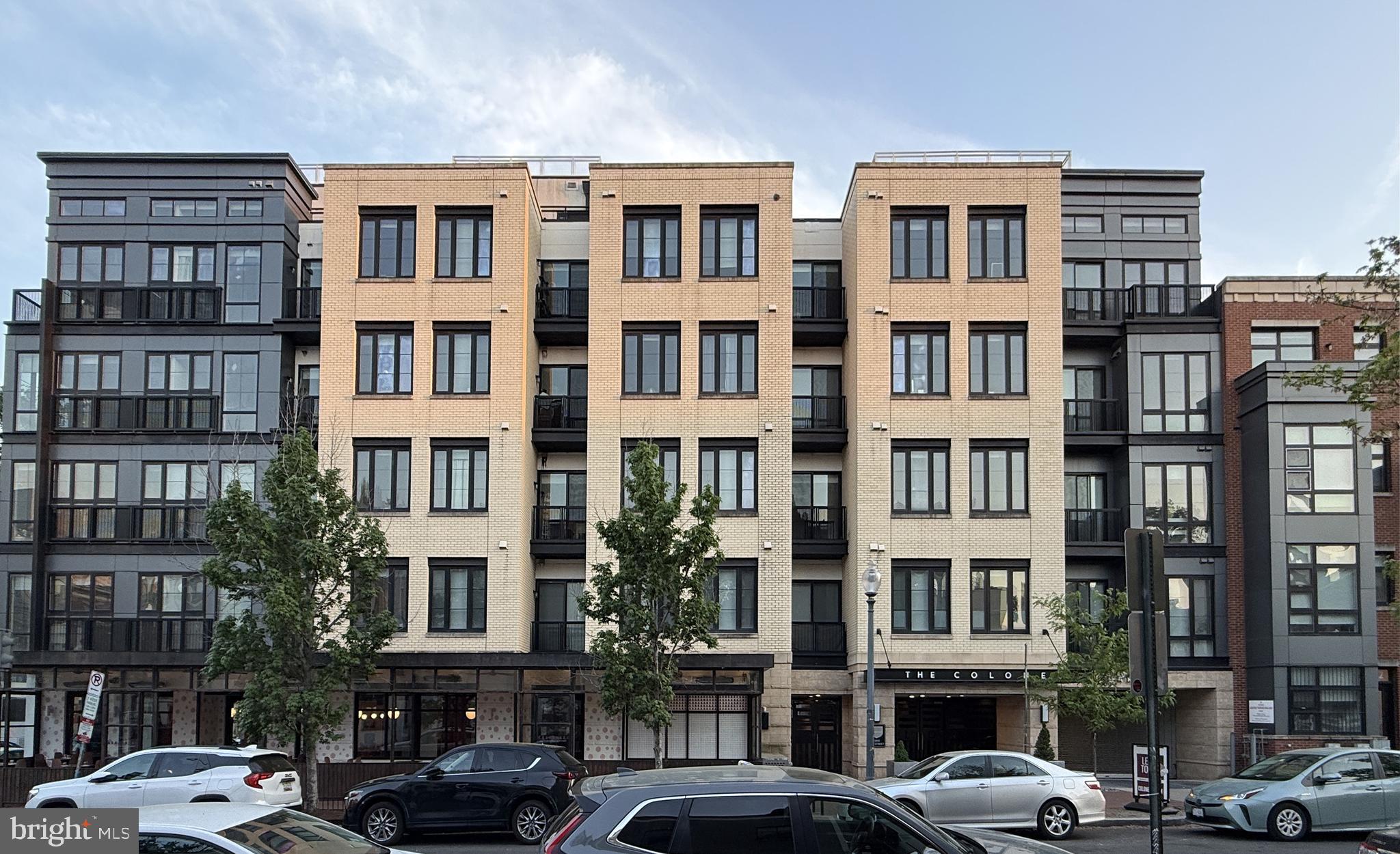 1250 9th Street Northwest, Unit 218 Washington, DC 20001 - Photo 1 of 18 a front view of a building with lot of cars and trees