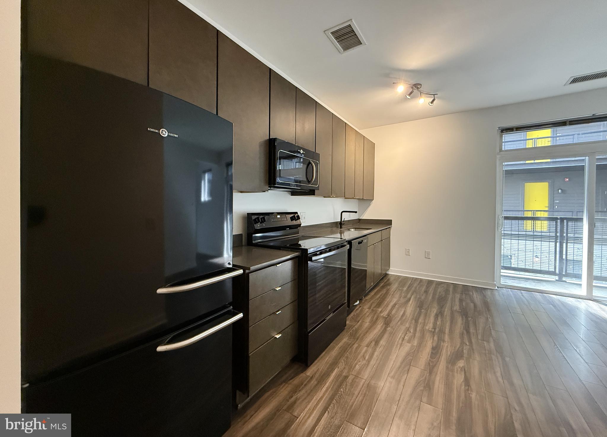 1250 9th Street Northwest, Unit 218 Washington, DC 20001 - Photo 2 of 18 a kitchen with stainless steel appliances a refrigerator a stove a sink and a oven