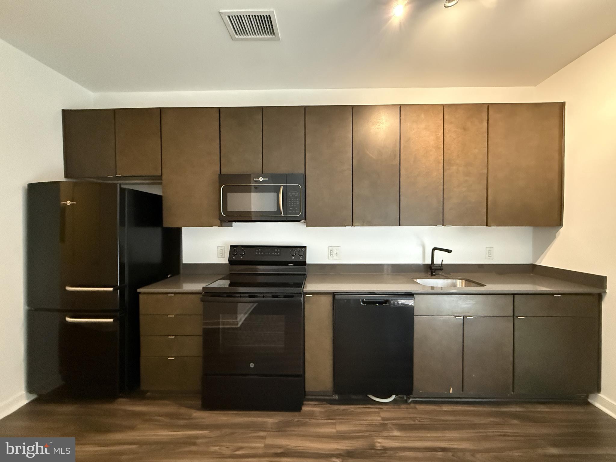1250 9th Street Northwest, Unit 218 Washington, DC 20001 - Photo 3 of 18 a kitchen with stainless steel appliances granite countertop a refrigerator and a sink