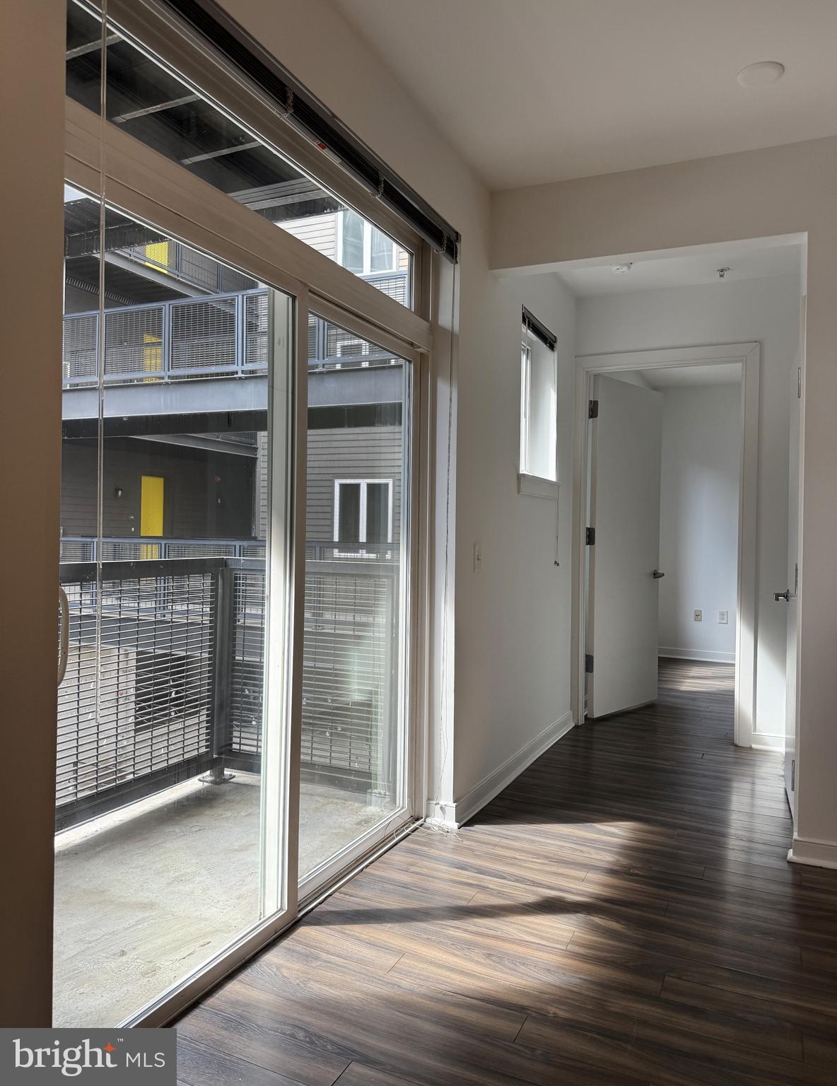 1250 9th Street Northwest, Unit 218 Washington, DC 20001 - Photo 4 of 18 an empty room with wooden floor and windows