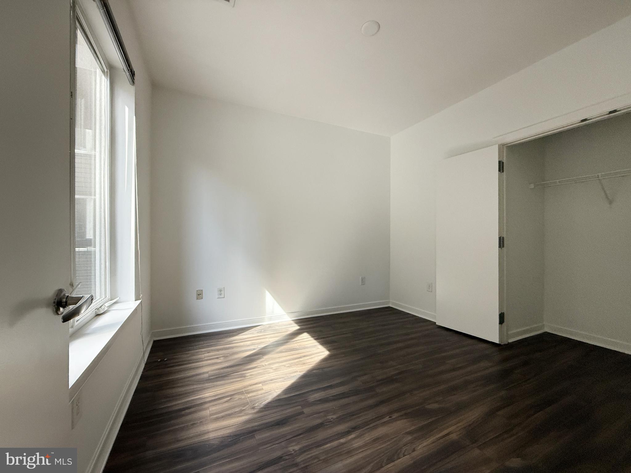 1250 9th Street Northwest, Unit 218 Washington, DC 20001 - Photo 8 of 18 wooden floor in an empty room with a window