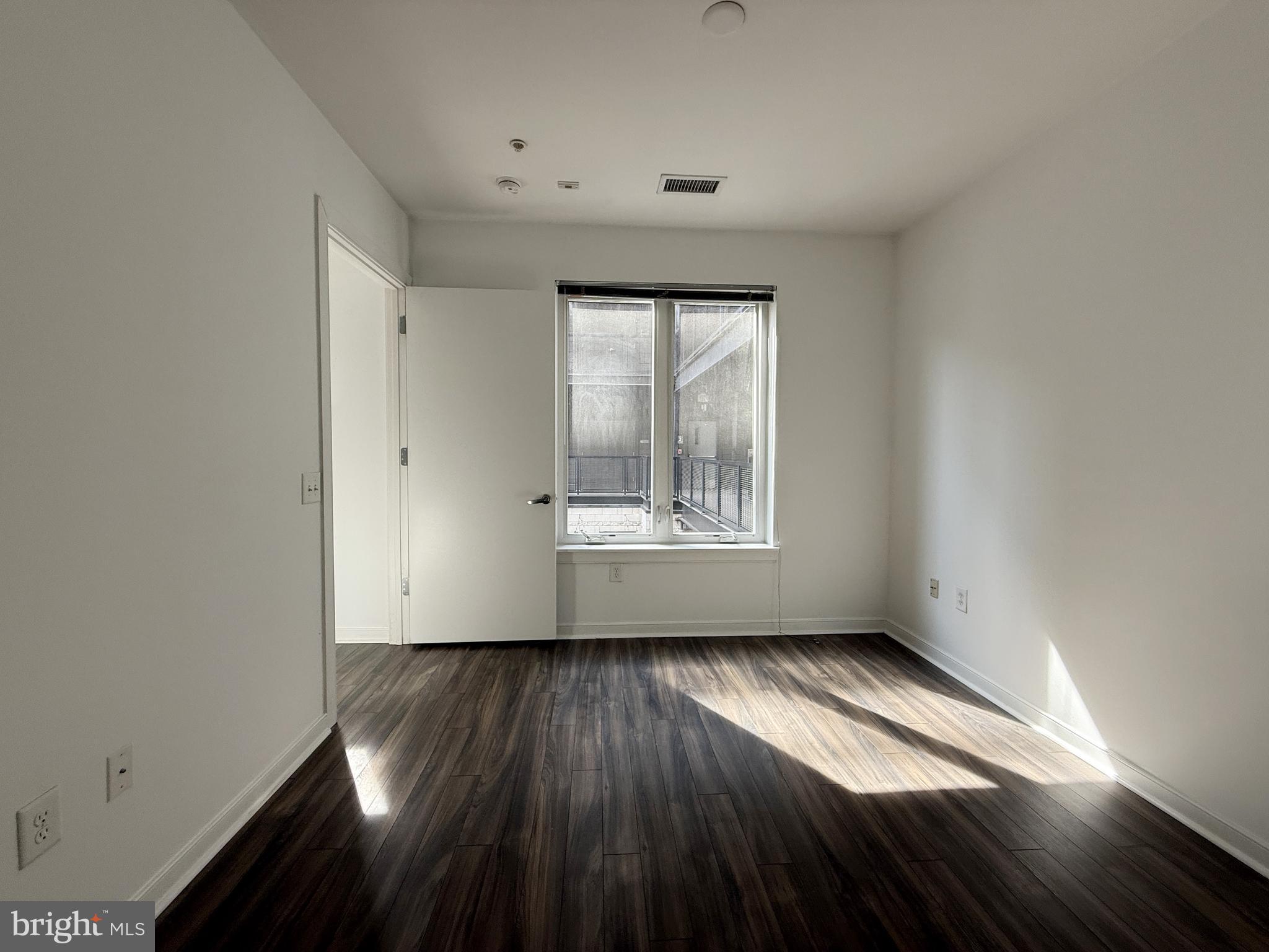 1250 9th Street Northwest, Unit 218 Washington, DC 20001 - Photo 9 of 18 an empty room with wooden floor and windows