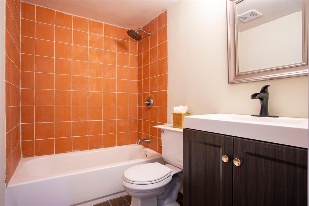 7027 Alpha Road, Unit 1 Dallas, TX 75240 - Photo 3 of 8 a bathroom with a sink a toilet and shower