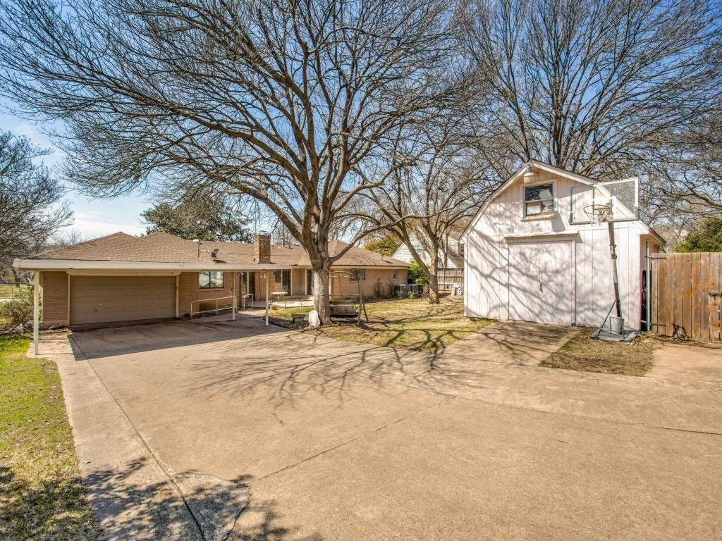 7027 Alpha Road, Unit 1 Dallas, TX 75240 - Photo 6 of 8 a tree in front of a white house
